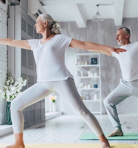man and woman doing yoga