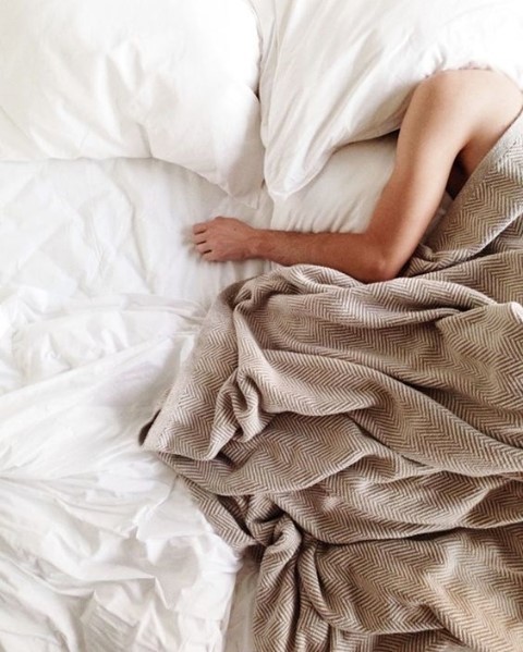 man sleeping with head under pillow